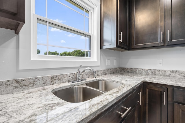 407 W Adamson St, Miller, MO 65707 - kitchen with dark brown cabinetry and light stone countertops