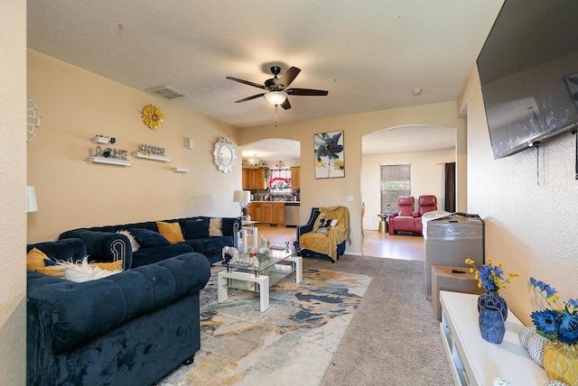 5441 Basswood Ct W, Springfield, MO 65802 - carpeted living room with arched walkways and ceiling fan