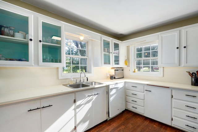 223 E Silsby St, Springfield, MO 65807 - kitchen featuring white dishwasher, white cabinetry, dark wood-type flooring, and healthy amount of natural light