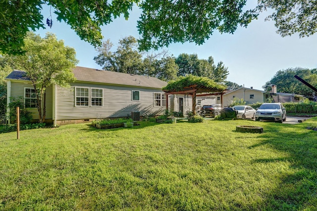223 E Silsby St, Springfield, MO 65807 - back of house with a pergola, crawl space, and a yard