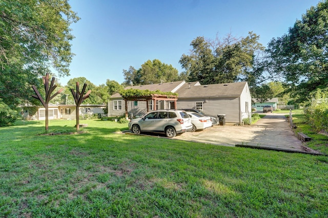 223 E Silsby St, Springfield, MO 65807 - back of property featuring a lawn and driveway