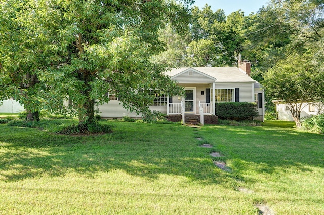 223 E Silsby St, Springfield, MO 65807 - view of front facade featuring a porch, a front lawn, and a chimney