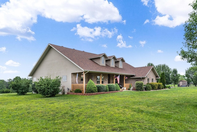 106 Finch Dr, Strafford, MO 65757 - cape cod house featuring covered porch, a front lawn, brick siding, and a shingled roof