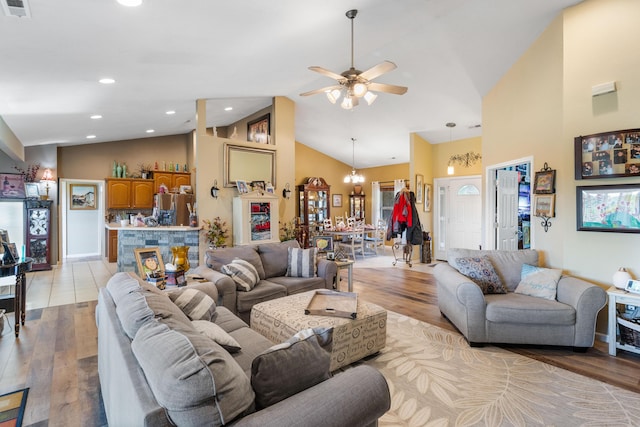 106 Finch Dr, Strafford, MO 65757 - living room featuring light wood finished floors, high vaulted ceiling, ceiling fan, a chandelier, and healthy amount of natural light
