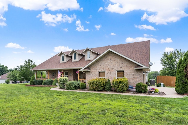 106 Finch Dr, Strafford, MO 65757 - view of front facade featuring brick siding, roof with shingles, and covered porch