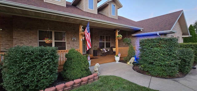 106 Finch Dr, Strafford, MO 65757 - property entrance with covered porch, roof with shingles, and brick siding