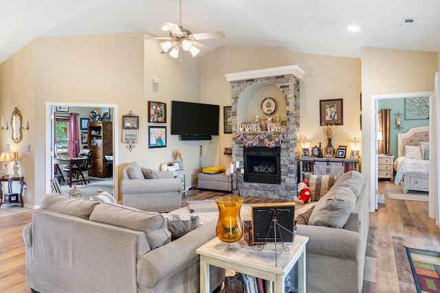 106 Finch Dr, Strafford, MO 65757 - living area with lofted ceiling, ceiling fan, a stone fireplace, and light wood-type flooring