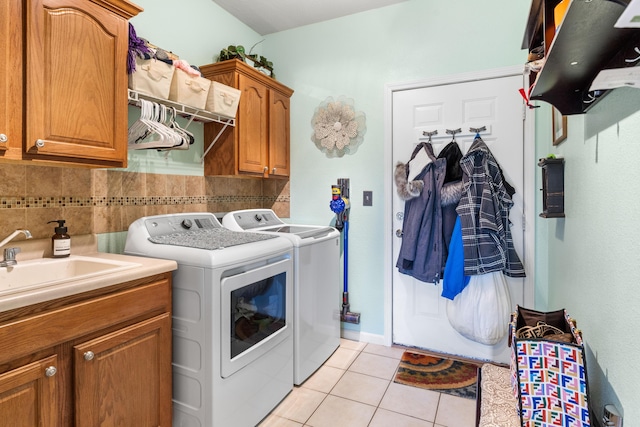 106 Finch Dr, Strafford, MO 65757 - laundry room featuring washer and dryer, cabinet space, and light tile patterned flooring