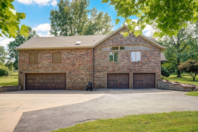 623 E Weaver Rd, Springfield, MO 65810 - view of side of home featuring an attached garage, concrete driveway, brick siding, and roof with shingles