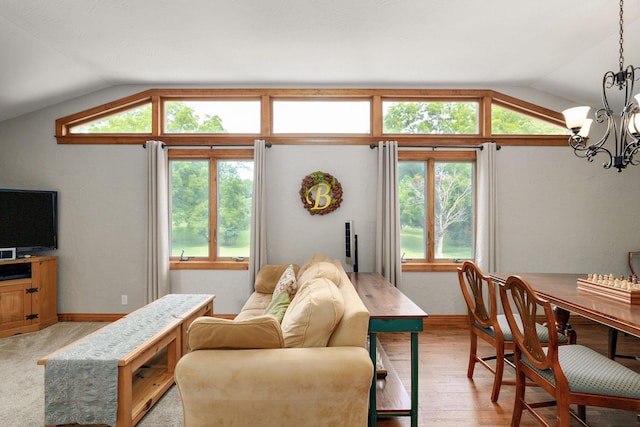 623 E Weaver Rd, Springfield, MO 65810 - living room featuring vaulted ceiling, a chandelier, healthy amount of natural light, and light wood finished floors