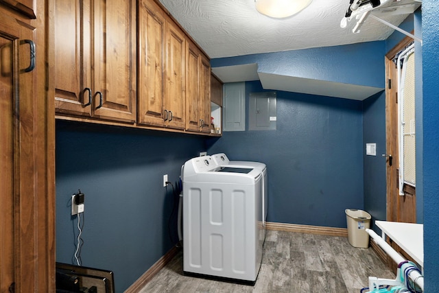 623 E Weaver Rd, Springfield, MO 65810 - laundry room with cabinet space, washing machine and clothes dryer, electric panel, and light wood-style floors
