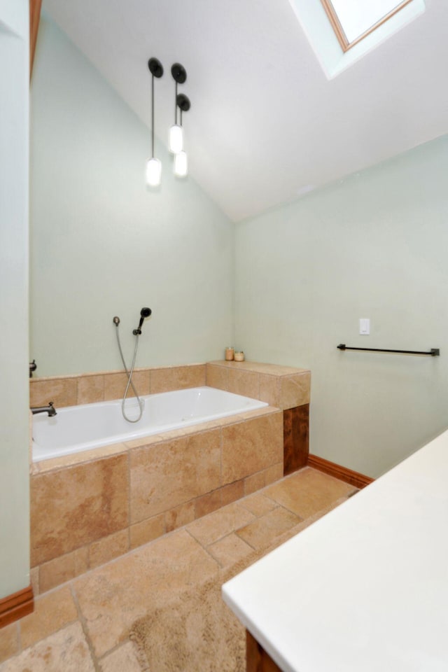 623 E Weaver Rd, Springfield, MO 65810 - bathroom featuring lofted ceiling, a bath, and a skylight