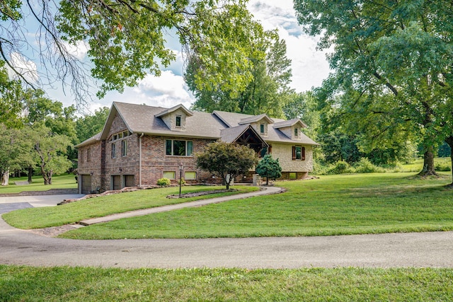 623 E Weaver Rd, Springfield, MO 65810 - cape cod house featuring an attached garage, concrete driveway, a front lawn, and brick siding