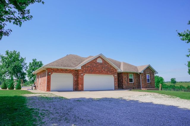 258 State Highway 32, Buffalo, MO 65622 - view of front of house featuring an attached garage, concrete driveway, brick siding, and a front yard