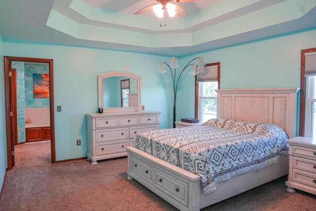 258 State Highway 32, Buffalo, MO 65622 - bedroom with dark carpet, a raised ceiling, and a ceiling fan