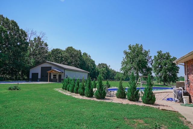 258 State Highway 32, Buffalo, MO 65622 - view of grassy yard with a garage and an outdoor pool