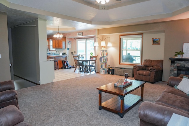 258 State Highway 32, Buffalo, MO 65622 - living area featuring ceiling fan, a chandelier, a raised ceiling, and light colored carpet