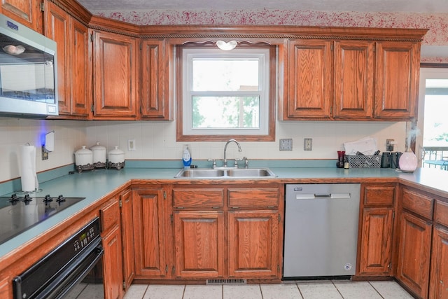 258 State Highway 32, Buffalo, MO 65622 - kitchen with black appliances, brown cabinetry, and decorative backsplash
