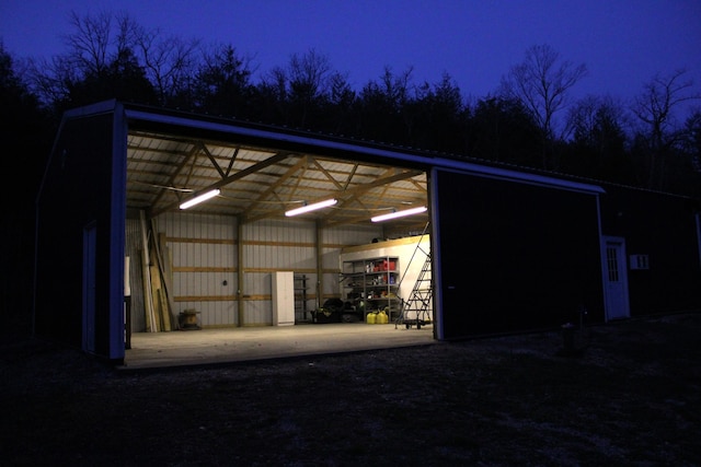2240 Mease Dr, Reeds Spring, MO 65737 - garage at night with a detached carport