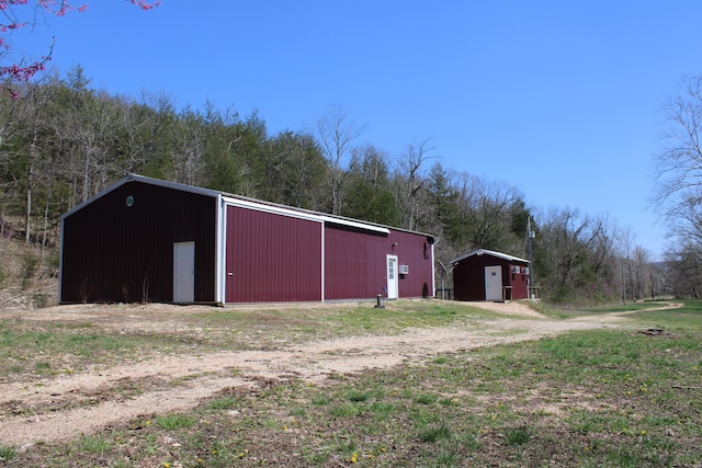2240 Mease Dr, Reeds Spring, MO 65737 - view of pole building featuring a forest view
