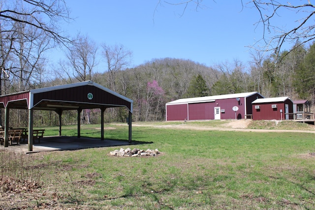 2240 Mease Dr, Reeds Spring, MO 65737 - view of green lawn featuring an outbuilding, a gazebo, a wooded view, an outdoor structure, and a mountain view