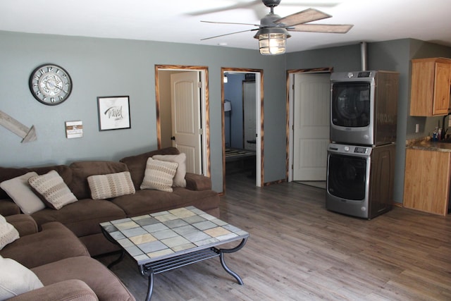 2240 Mease Dr, Reeds Spring, MO 65737 - living room with stacked washer / dryer, a ceiling fan, and light wood-style flooring