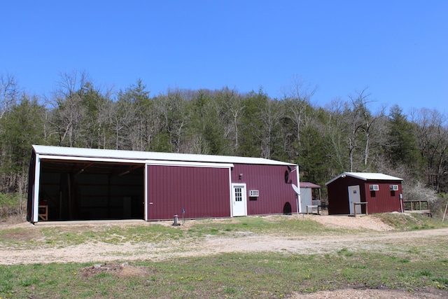 2240 Mease Dr, Reeds Spring, MO 65737 - view of pole building with a forest view and a carport