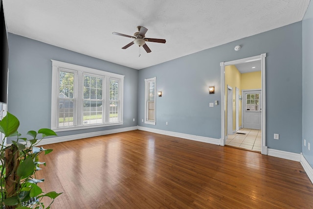 1201 N Broadway Ave, Springfield, MO 65802 - empty room featuring a ceiling fan, wood finished floors, and a smoke detector