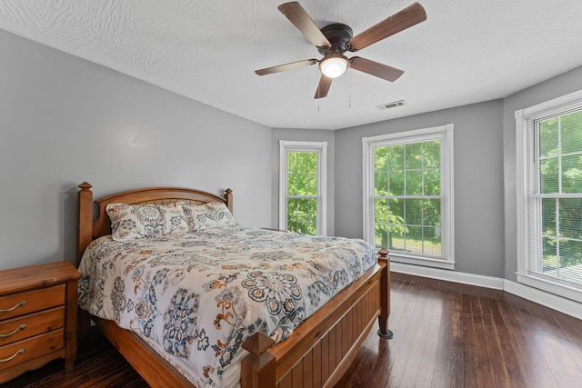 1201 N Broadway Ave, Springfield, MO 65802 - bedroom with dark wood-style floors, a ceiling fan, and a textured ceiling