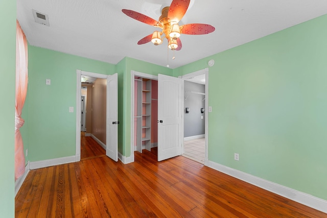 1201 N Broadway Ave, Springfield, MO 65802 - unfurnished bedroom with a closet, wood finished floors, and ceiling fan
