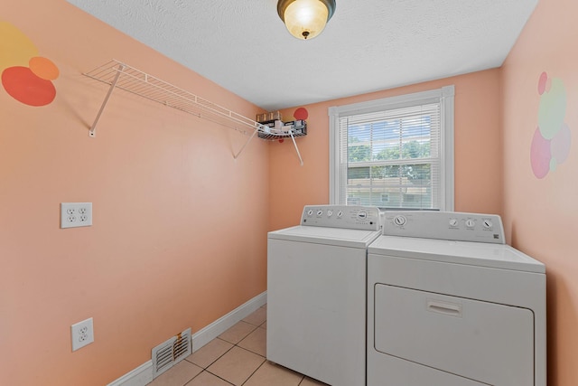 1201 N Broadway Ave, Springfield, MO 65802 - laundry room featuring independent washer and dryer, light tile patterned floors, and a textured ceiling
