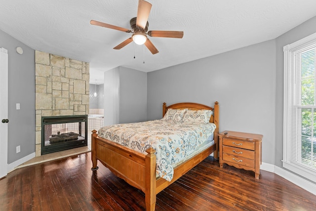 1201 N Broadway Ave, Springfield, MO 65802 - bedroom with hardwood / wood-style flooring, a multi sided fireplace, and a ceiling fan
