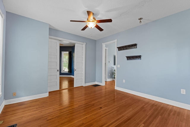 1201 N Broadway Ave, Springfield, MO 65802 - spare room featuring ceiling fan and wood finished floors