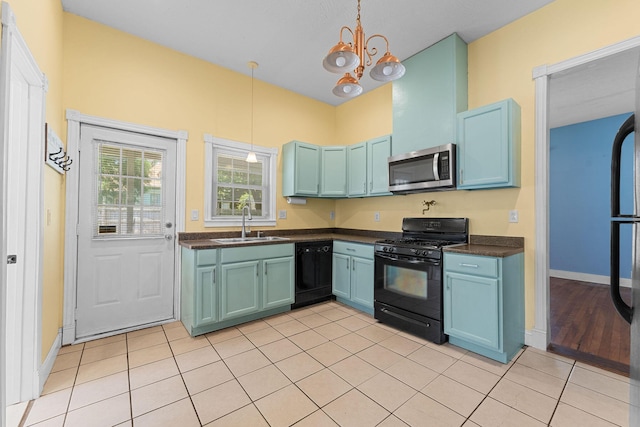 1201 N Broadway Ave, Springfield, MO 65802 - kitchen with black appliances, dark countertops, a chandelier, hanging light fixtures, and blue cabinets