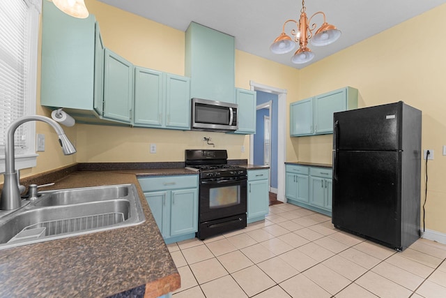 1201 N Broadway Ave, Springfield, MO 65802 - kitchen featuring black appliances, dark countertops, blue cabinetry, and pendant lighting