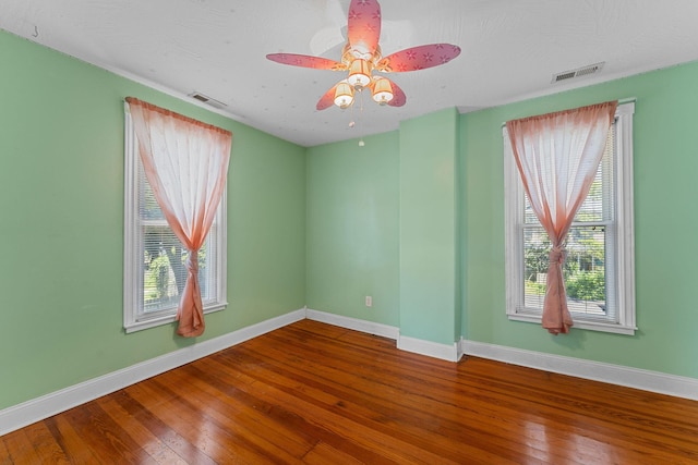 1201 N Broadway Ave, Springfield, MO 65802 - unfurnished room with wood-type flooring, plenty of natural light, and ceiling fan