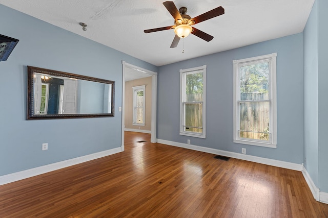 1201 N Broadway Ave, Springfield, MO 65802 - spare room with wood finished floors and a ceiling fan