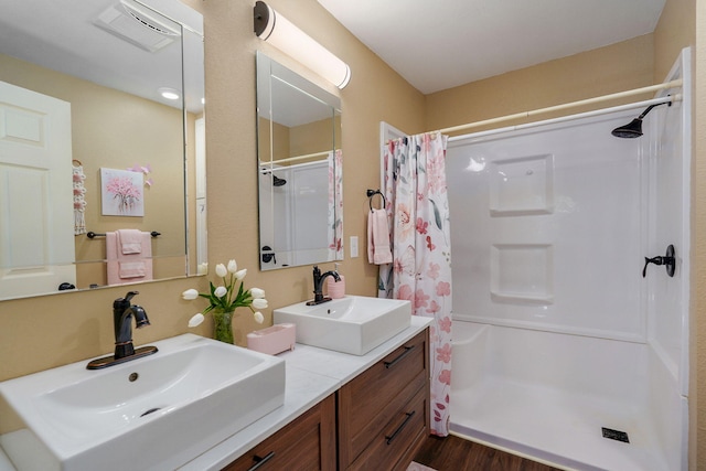 12655 Lawrence Unit 2155, Mount Vernon, MO 65712 - bathroom featuring wood finished floors, a shower with shower curtain, and double vanity