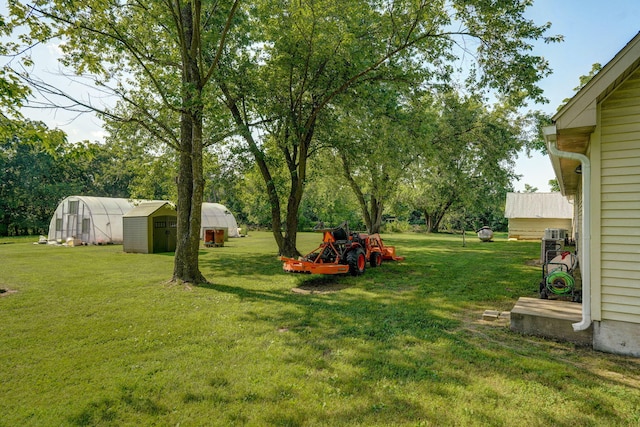 12655 Lawrence Unit 2155, Mount Vernon, MO 65712 - view of green lawn featuring a storage unit and view of scattered trees