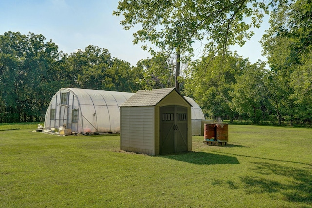 12655 Lawrence Unit 2155, Mount Vernon, MO 65712 - view of greenhouse featuring a lawn, a storage shed, and view of scattered trees