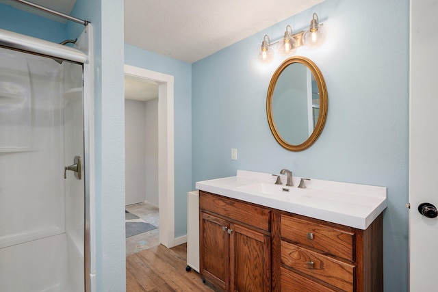 114 N Hobbs St, Miller, MO 65707 - bathroom with wood finished floors, vanity, and a shower