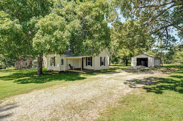 114 N Hobbs St, Miller, MO 65707 - view of front of property with a garage, an outdoor structure, a front yard, covered porch, and driveway