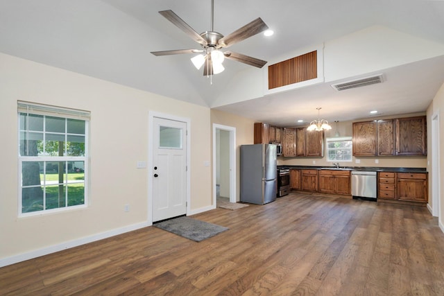114 N Hobbs St, Miller, MO 65707 - kitchen featuring stainless steel appliances, dark countertops, a chandelier, dark wood finished floors, and brown cabinetry