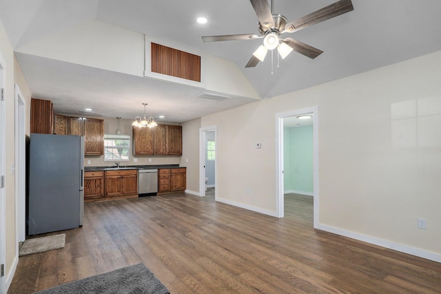 114 N Hobbs St, Miller, MO 65707 - kitchen featuring freestanding refrigerator, stainless steel dishwasher, dark countertops, brown cabinetry, and dark wood-type flooring