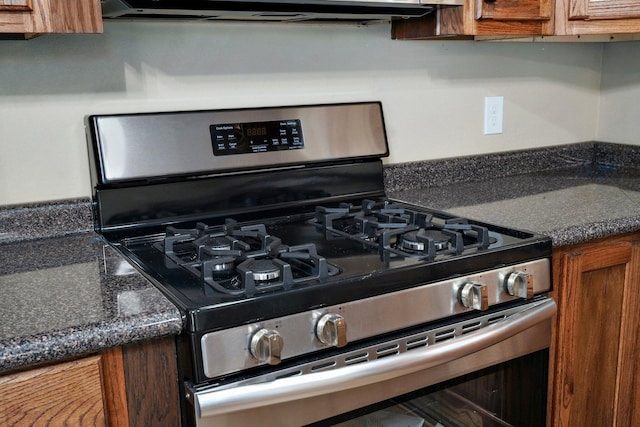 114 N Hobbs St, Miller, MO 65707 - kitchen view of stainless steel range with gas cooktop, brown cabinetry, and dark countertops