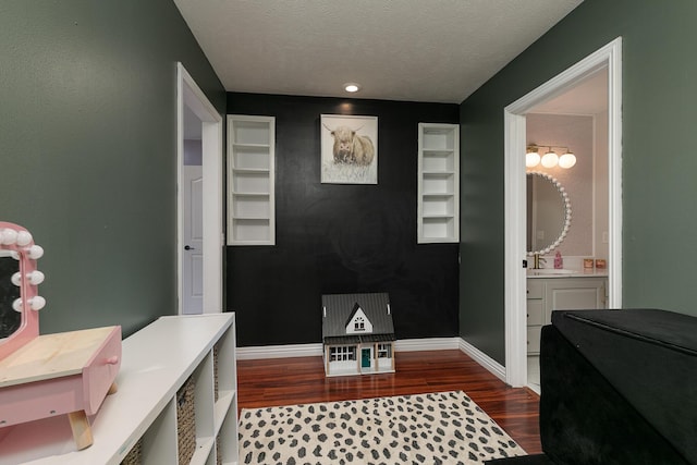 295 Headwaters Dr, Marshfield, MO 65706 - interior space featuring wood finished floors, a textured ceiling, and built in shelves