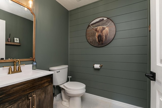 295 Headwaters Dr, Marshfield, MO 65706 - half bathroom with vanity, wood walls, tile patterned flooring, and a textured ceiling