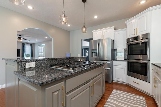 295 Headwaters Dr, Marshfield, MO 65706 - kitchen featuring stainless steel appliances, white cabinetry, ceiling fan, a center island, and dark wood-style flooring