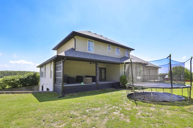 295 Headwaters Dr, Marshfield, MO 65706 - rear view of property with a trampoline, stucco siding, a lawn, a patio, and a ceiling fan