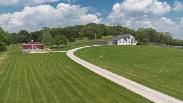 295 Headwaters Dr, Marshfield, MO 65706 - view of green lawn featuring a pole building, an outbuilding, a wooded view, and driveway